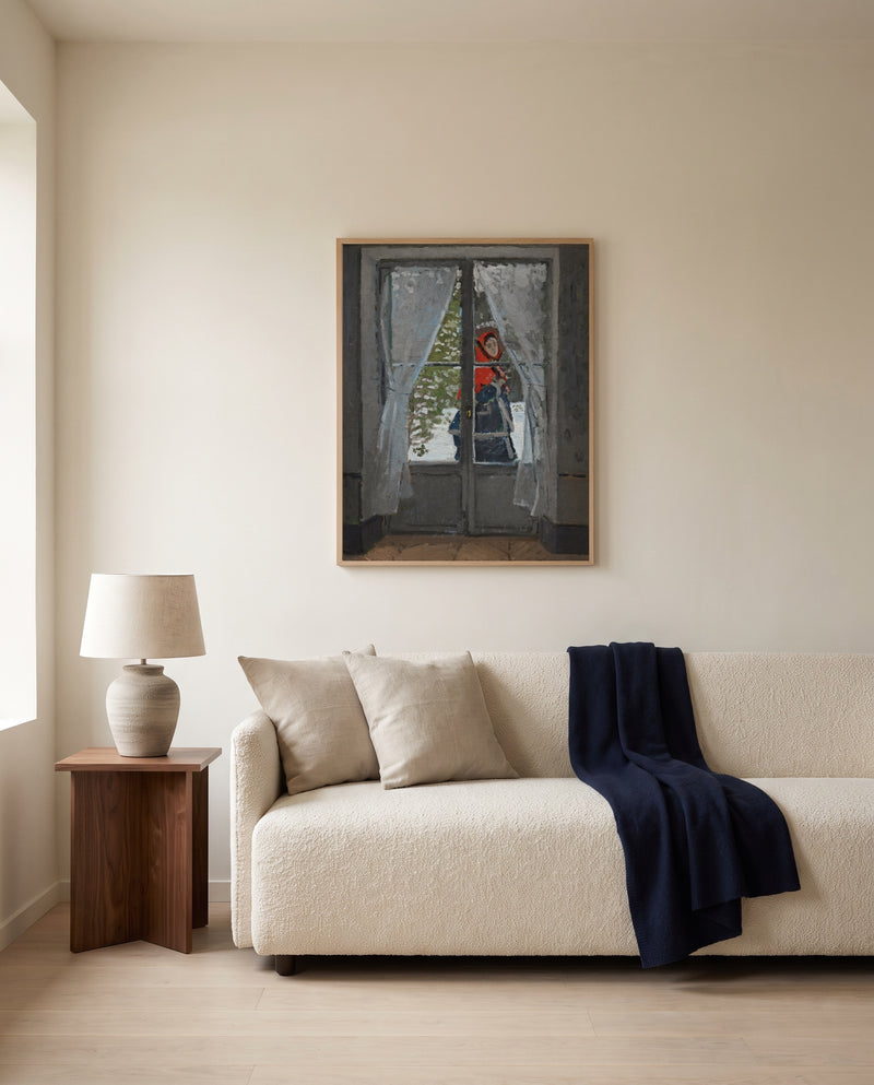 The Red Kerchief by Claude Monet framed in natural oak above a cream sofa in a warm living room