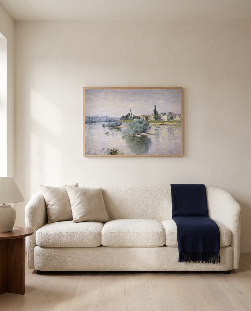The Seine at Lavacourt by Claude Monet framed in natural oak above a cream sofa in a warm living room