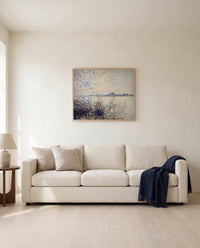 The Seine near Argenteuil by Claude Monet framed in natural oak above a cream sofa in a warm living room