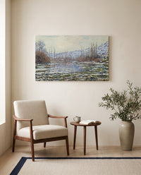 The Thaw at Vétheuil by Claude Monet as a stretched canvas above a linen lounge chair in a reading corner