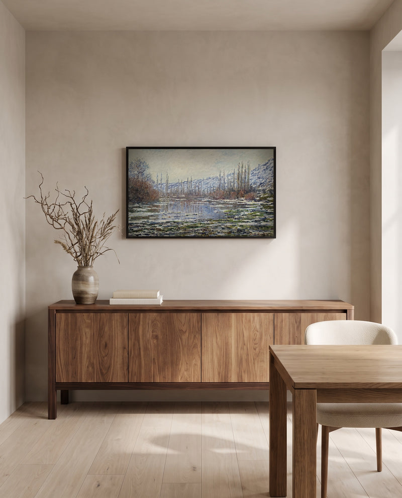 The Thaw at Vétheuil by Claude Monet in a black frame above a walnut sideboard in a dining room