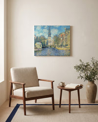 The Zuiderkerk, Amsterdam by Claude Monet as a stretched canvas above a linen lounge chair in a reading corner