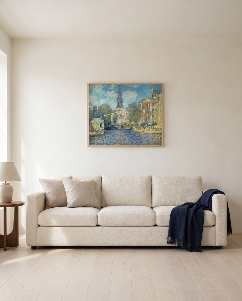 The Zuiderkerk, Amsterdam by Claude Monet framed in natural oak above a cream sofa in a warm living room