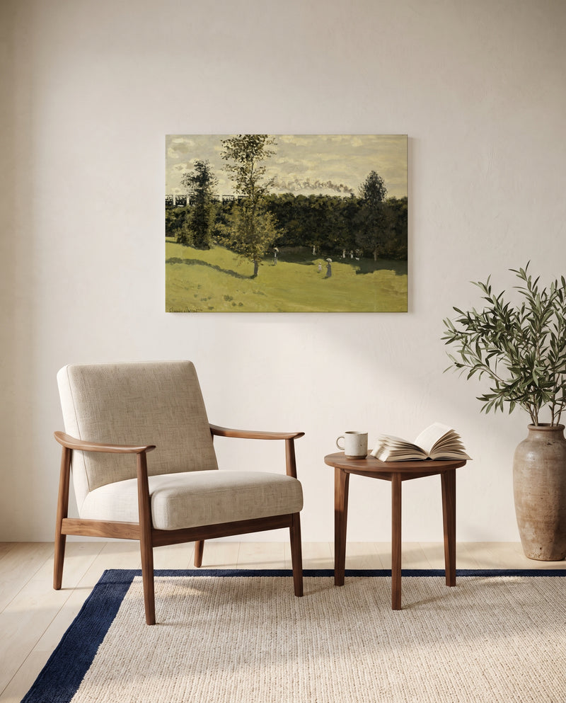 Train in the Countryside by Claude Monet as a stretched canvas above a linen lounge chair in a reading corner