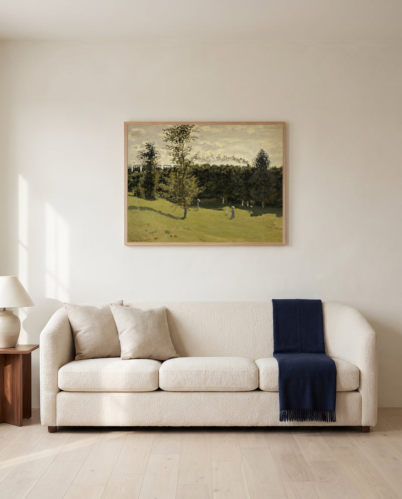 Train in the Countryside by Claude Monet framed in natural oak above a cream sofa in a warm living room