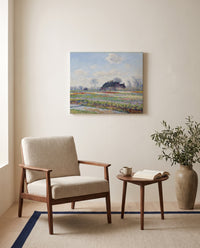 Tulip Fields at Sassenheim by Claude Monet as a stretched canvas above a linen lounge chair in a reading corner