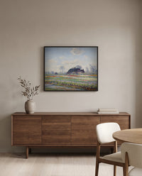 Tulip Fields at Sassenheim by Claude Monet in a black frame above a walnut sideboard in a dining room