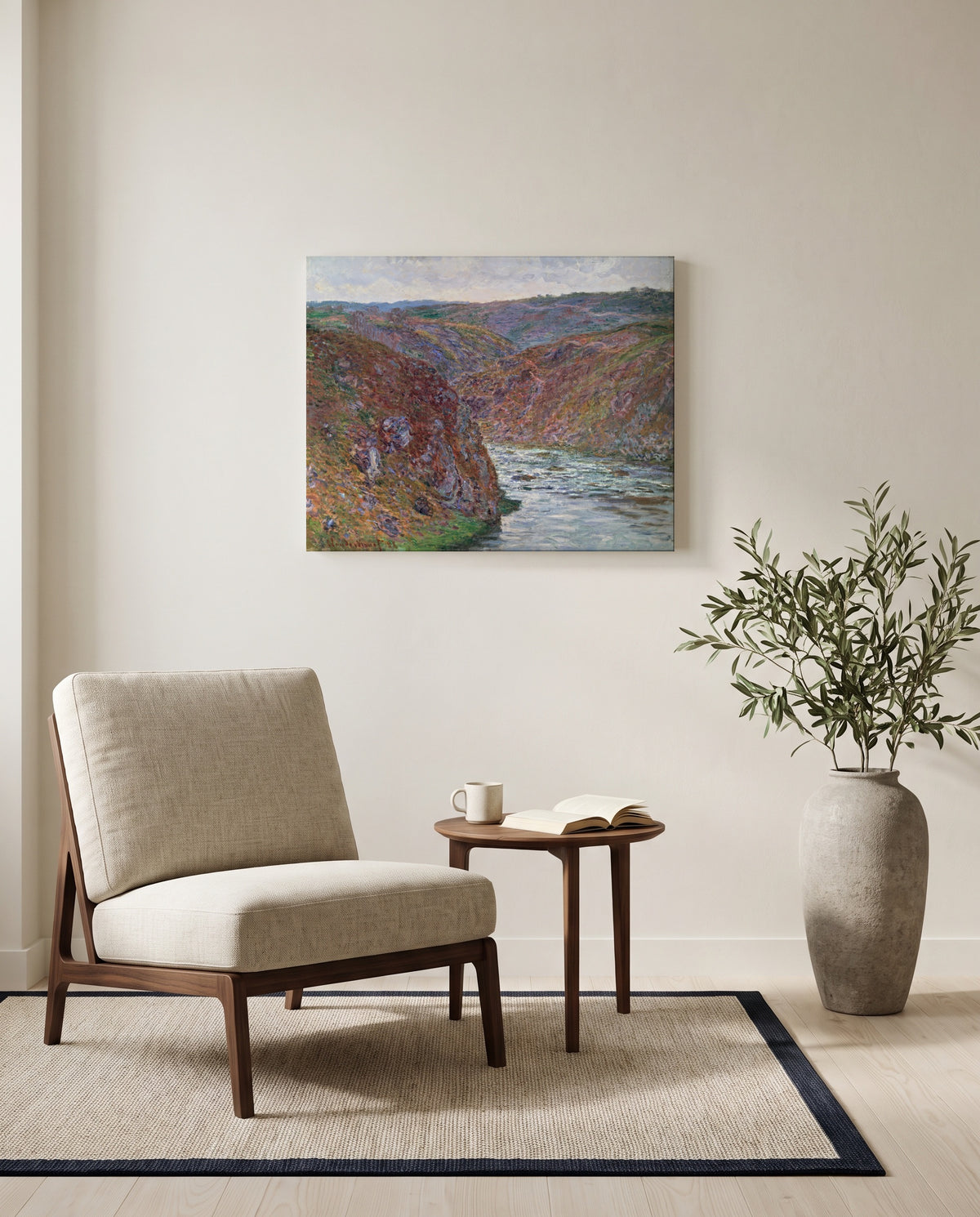 Valley of the Creuse by Claude Monet as a stretched canvas above a linen lounge chair in a reading corner