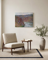 Valley of the Creuse by Claude Monet as a stretched canvas above a linen lounge chair in a reading corner
