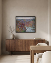Valley of the Creuse by Claude Monet in a black frame above a walnut sideboard in a dining room