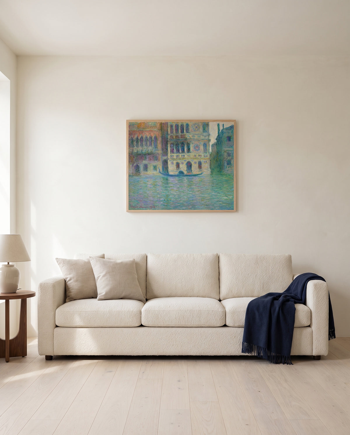 Palazzo Dario by Claude Monet framed in natural oak above a cream sofa in a warm living room