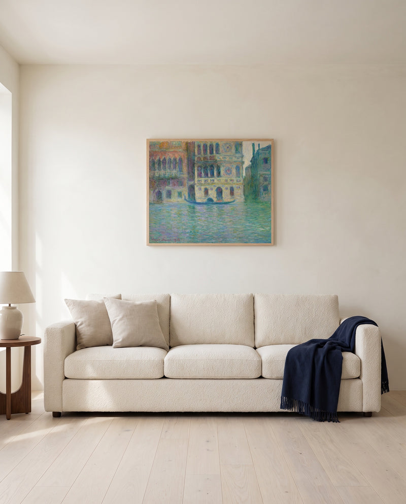 Palazzo Dario by Claude Monet framed in natural oak above a cream sofa in a warm living room