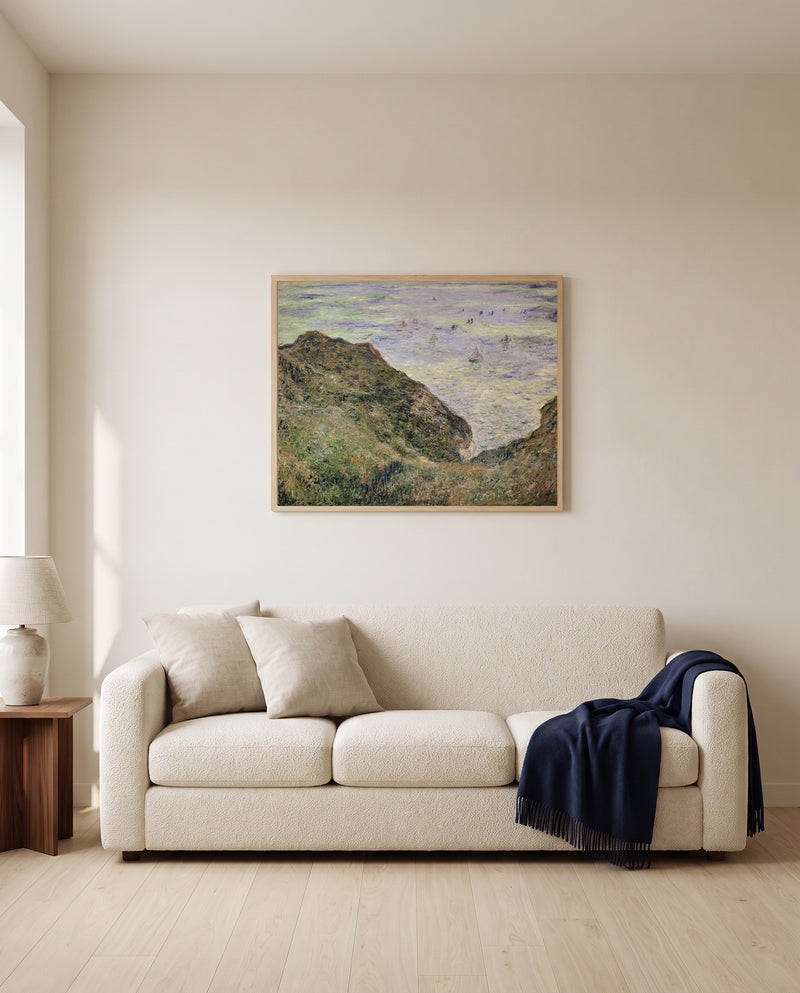 View over the Sea by Claude Monet framed in natural oak above a cream sofa in a warm living room