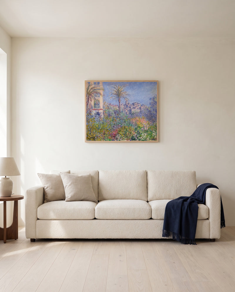 Villas at Bordighera by Claude Monet framed in natural oak above a cream sofa in a warm living room