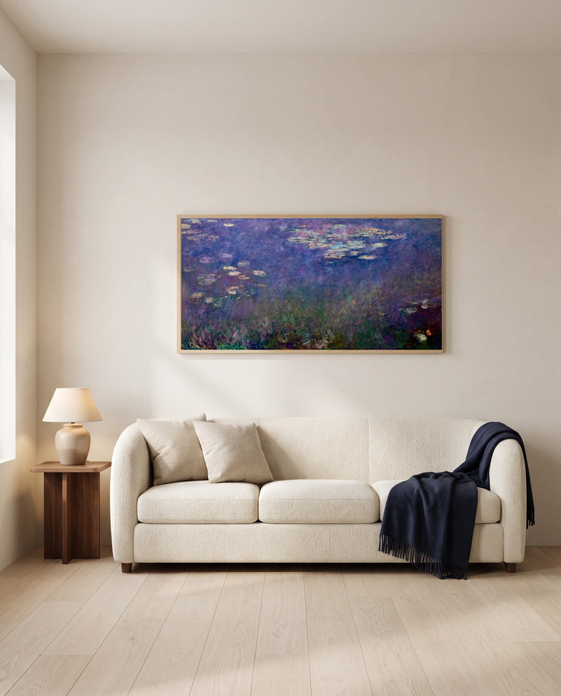 Water Lilies (Agapanthus) by Claude Monet framed in natural oak above a cream sofa in a warm living room