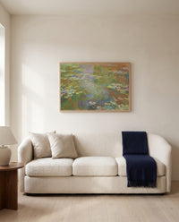 Water Lily Pond, 1917–19 by Claude Monet framed in natural oak above a cream sofa in a warm living room