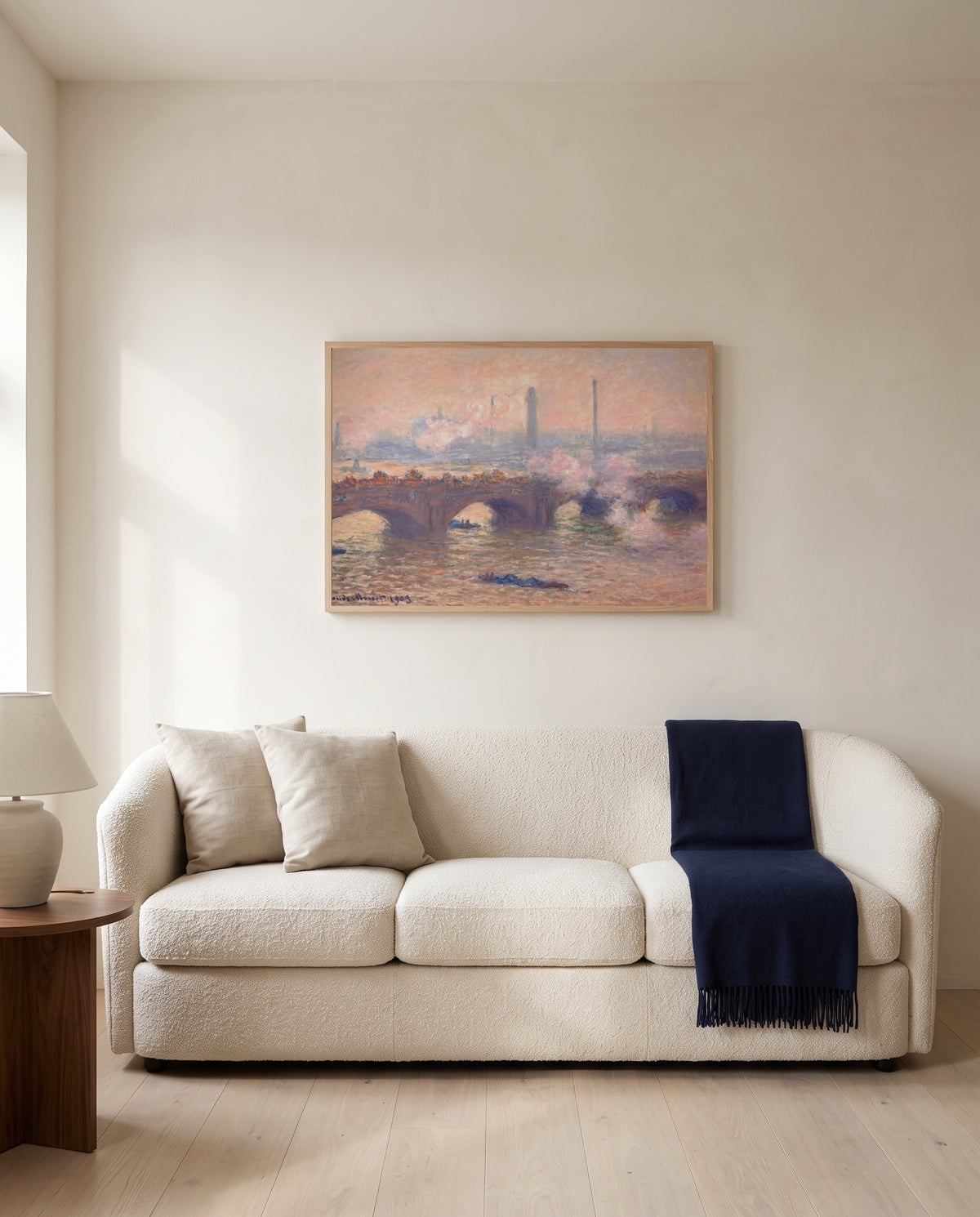 Waterloo Bridge, Gray Day by Claude Monet framed in natural oak above a cream sofa in a warm living room