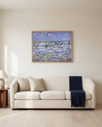 Waves Breaking by Claude Monet framed in natural oak above a cream sofa in a warm living room