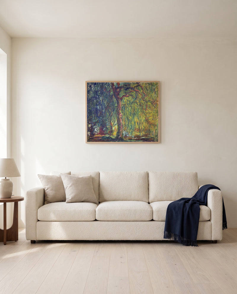 Weeping Willow by Claude Monet framed in natural oak above a cream sofa in a warm living room