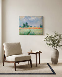 Wheatfield by Claude Monet as a stretched canvas above a linen lounge chair in a reading corner