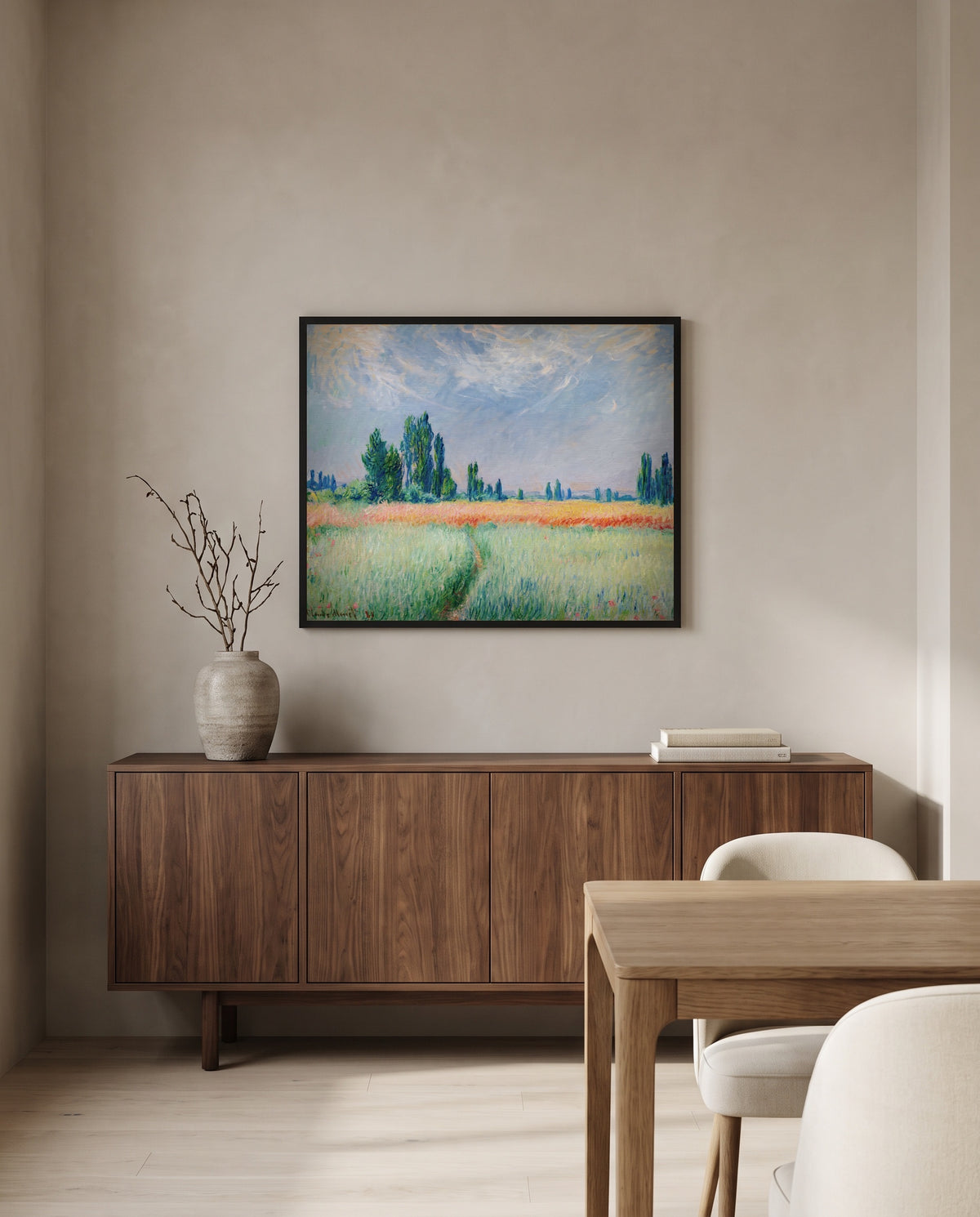 Wheatfield by Claude Monet in a black frame above a walnut sideboard in a dining room