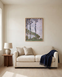 Wind Effect, Poplars by Claude Monet framed in natural oak above a cream sofa in a warm living room