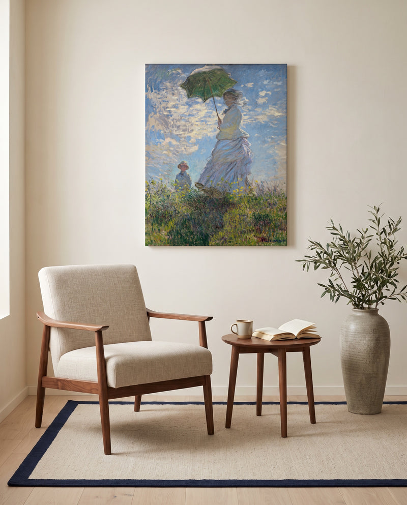 Woman with a Parasol by Claude Monet as a stretched canvas above a linen lounge chair in a reading corner