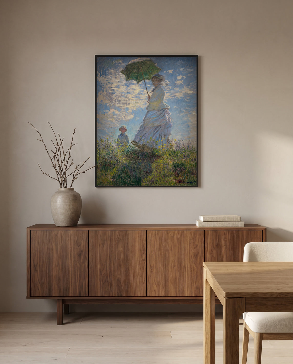 Woman with a Parasol by Claude Monet in a black frame above a walnut sideboard in a dining room