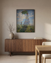 Woman with a Parasol by Claude Monet in a black frame above a walnut sideboard in a dining room