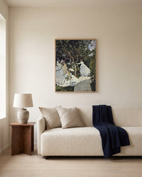 Women in the Garden by Claude Monet framed in natural oak above a cream sofa in a warm living room