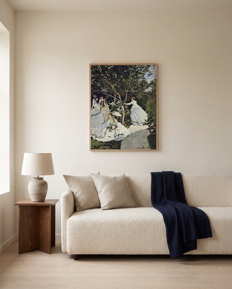 Women in the Garden by Claude Monet framed in natural oak above a cream sofa in a warm living room