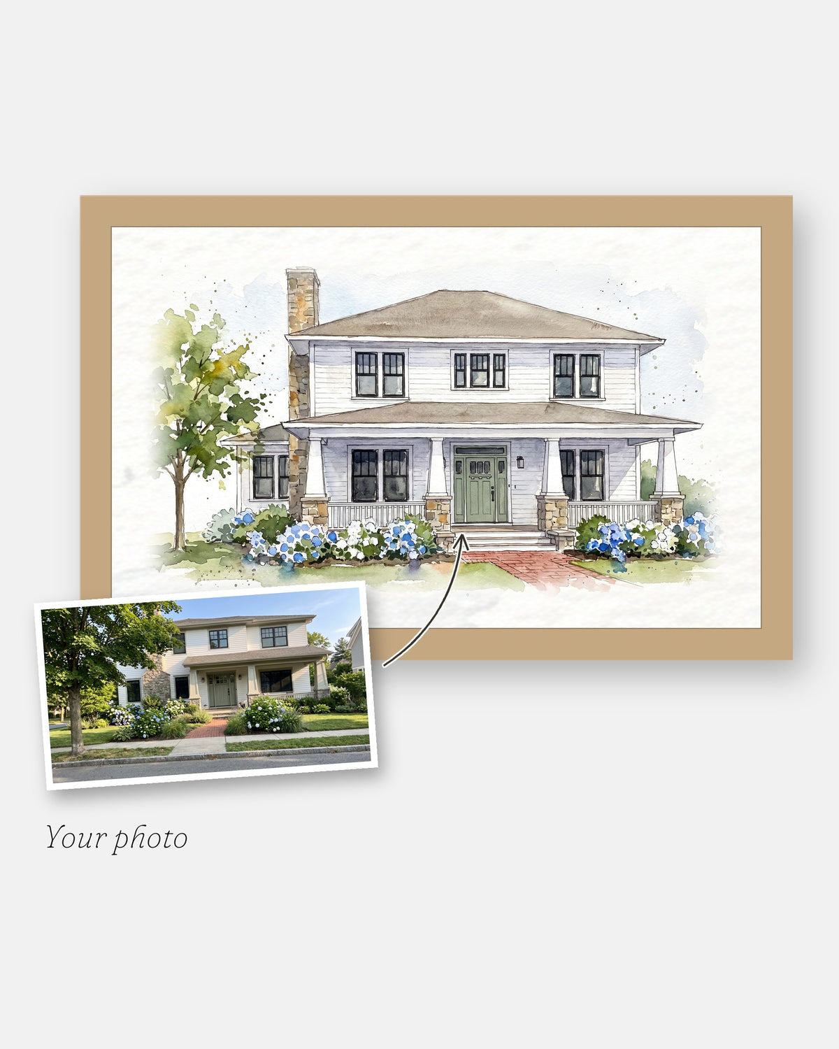 The customer's photo laid on the corner of the finished custom watercolor house painting, framed in natural wood