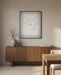 Custom line art cat portrait, in a black frame in a dining room