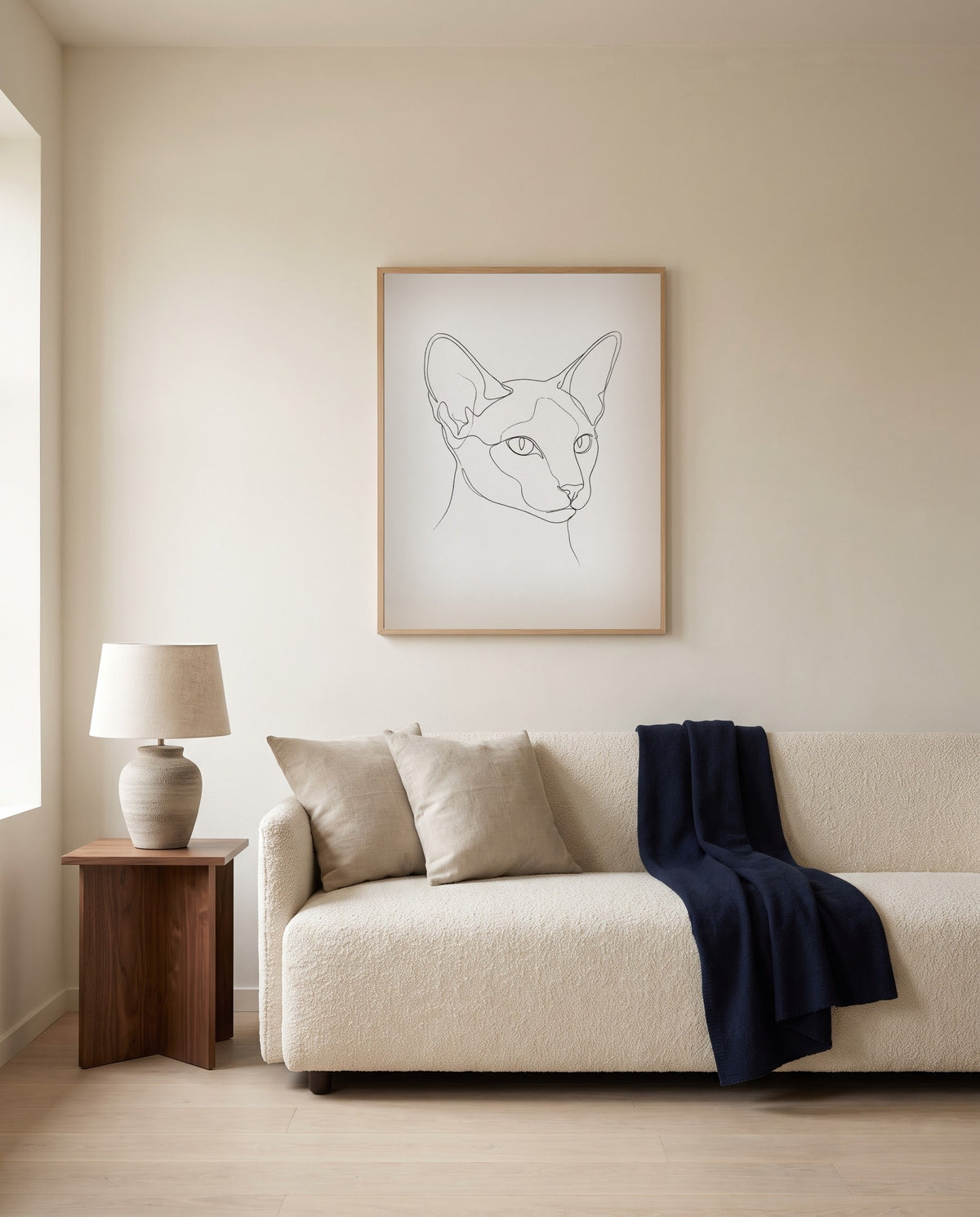 Custom line art cat portrait, framed above a sofa in a living room
