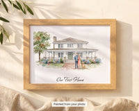Custom watercolor house portrait with family and dog painted in front, Our First Home script caption, framed flat-lay in dappled light