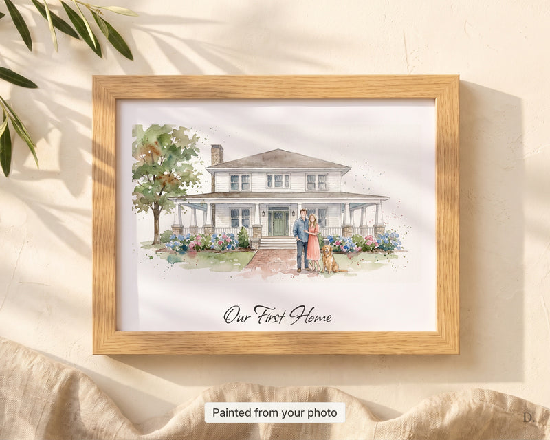 Custom watercolor house portrait with family and dog painted in front, Our First Home script caption, framed flat-lay in dappled light