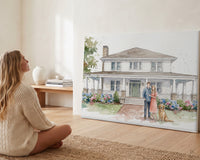 Woman admiring her custom watercolor house portrait with family and dog on a gallery canvas