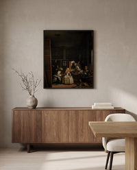 Las Meninas by Diego Velázquez in a black frame above a walnut sideboard in a dining room