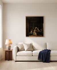 Las Meninas by Diego Velázquez framed in natural oak above a cream sofa in a warm living room