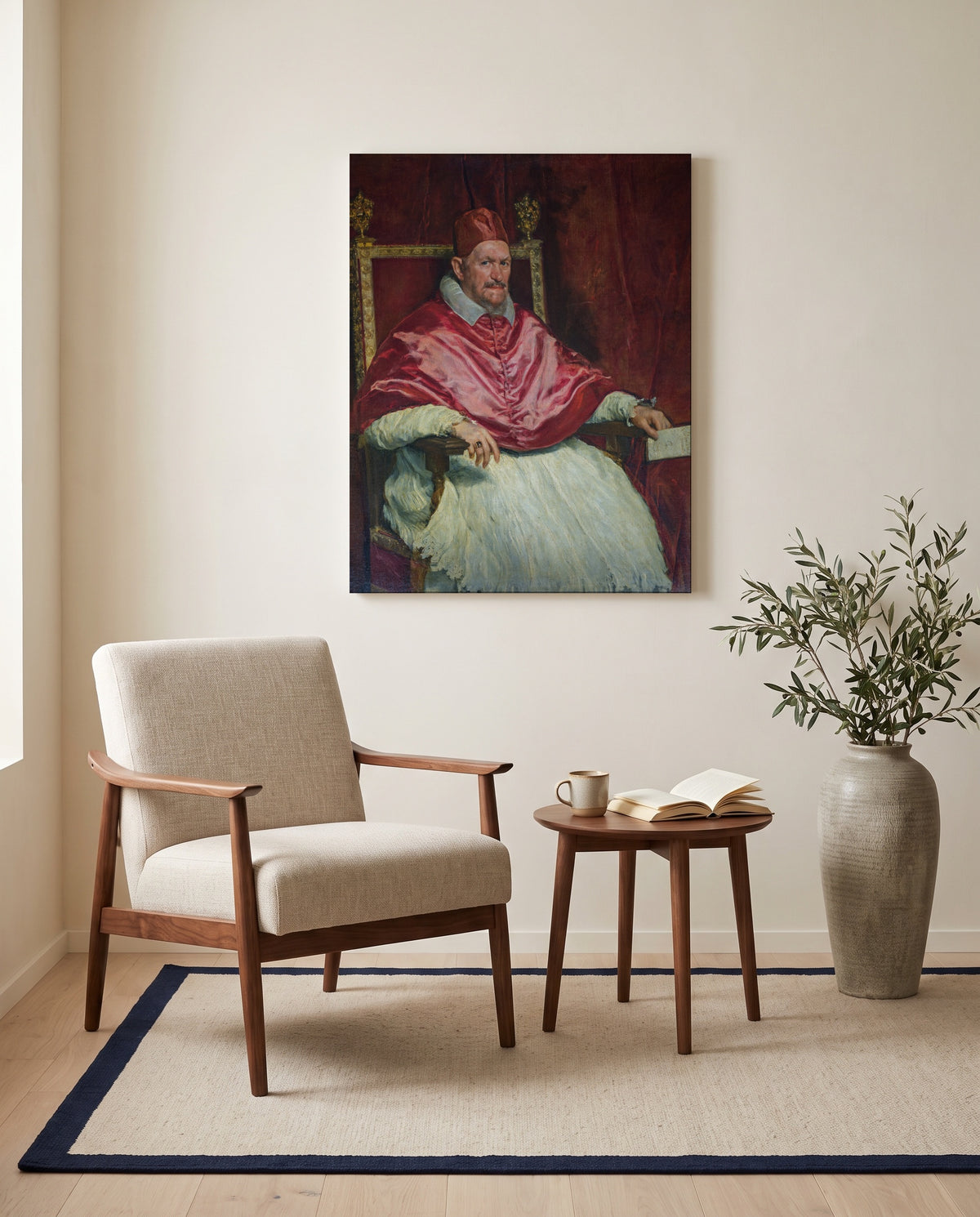 Pope Innocent X by Diego Velázquez as a stretched canvas above a linen lounge chair in a reading corner