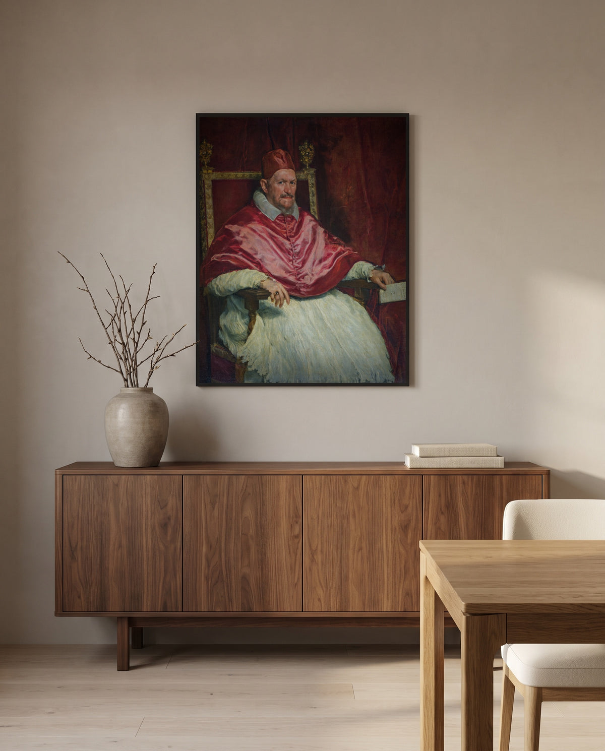 Pope Innocent X by Diego Velázquez in a black frame above a walnut sideboard in a dining room