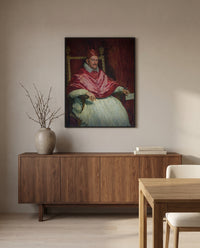 Pope Innocent X by Diego Velázquez in a black frame above a walnut sideboard in a dining room