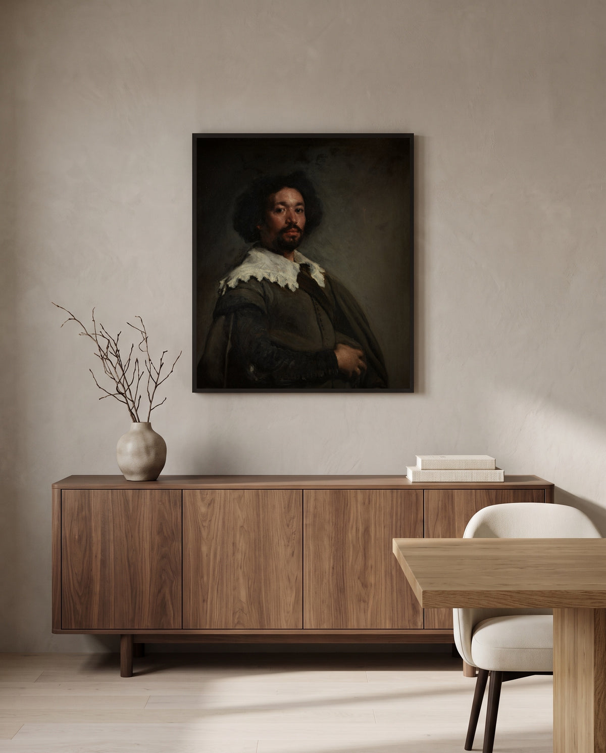 Juan de Pareja by Diego Velázquez in a black frame above a walnut sideboard in a dining room