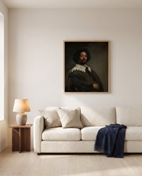 Juan de Pareja by Diego Velázquez framed in natural oak above a cream sofa in a warm living room