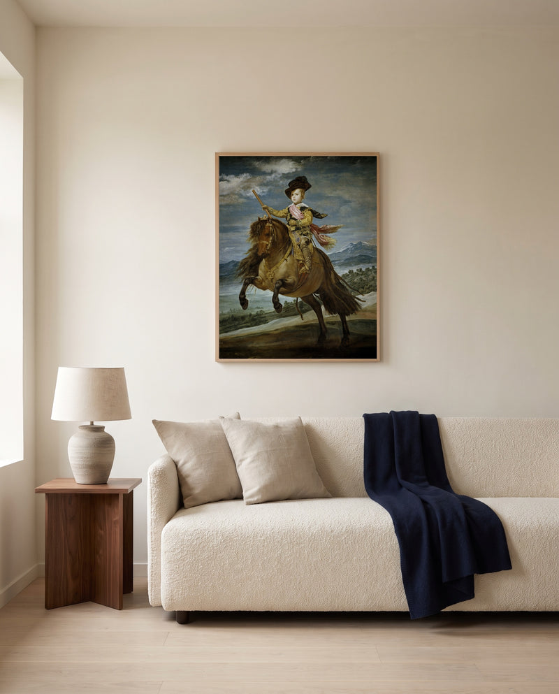 Prince Balthasar Charles by Diego Velázquez framed in natural oak above a cream sofa in a warm living room