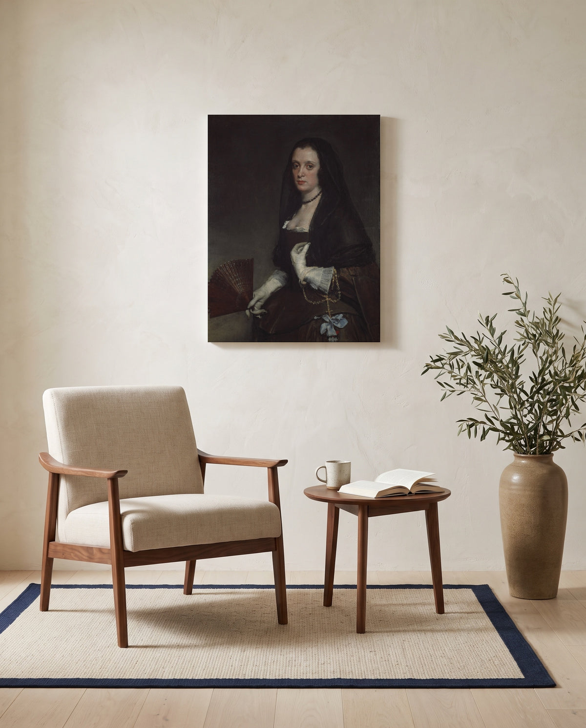 The Lady with a Fan by Diego Velázquez as a stretched canvas above a linen lounge chair in a reading corner