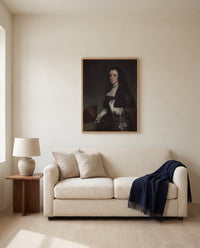 The Lady with a Fan by Diego Velázquez framed in natural oak above a cream sofa in a warm living room