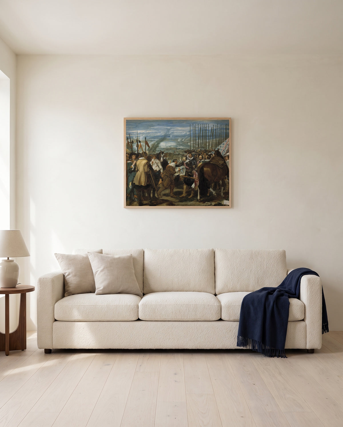 The Surrender of Breda by Diego Velázquez framed in natural oak above a cream sofa in a warm living room