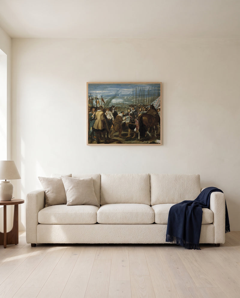 The Surrender of Breda by Diego Velázquez framed in natural oak above a cream sofa in a warm living room