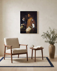 The Waterseller of Seville by Diego Velázquez as a stretched canvas above a linen lounge chair in a reading corner